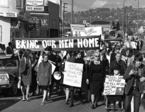 OAKLAND, California, February 1966—First women’s march against the Viet Nam War. Marching on the Oakland Induction Center Arlene is carrying the sign in center of first row.
