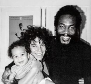 SAN FRANCISCO, California. November 1980—Family photo of Tongo, Arlene and Mali. (Cuban OSPAAAL poster in solidarity with Guinee Bissau and Cape Verde is on the wall.)